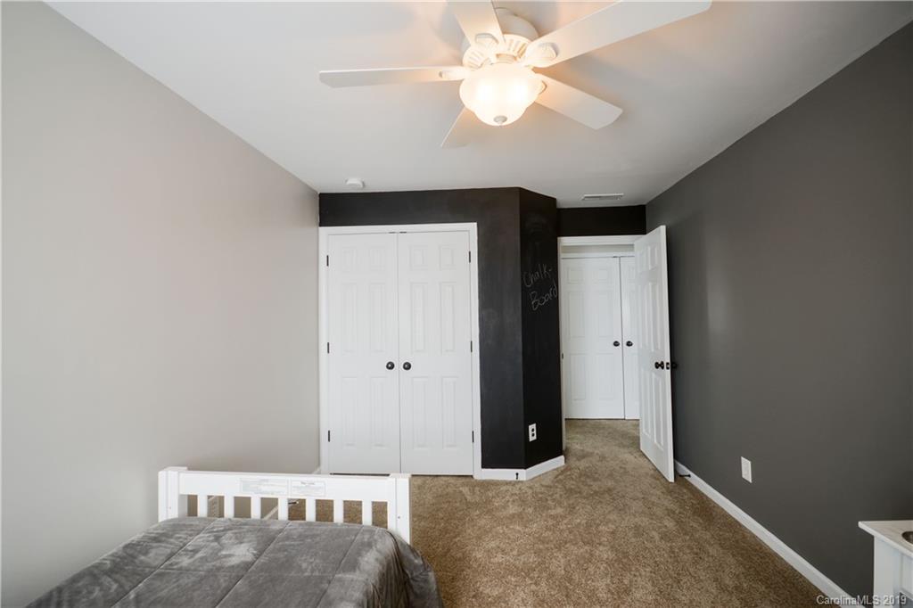 3550 Richard's Crossing Fort Mill, SC 29708 - Photo 24 of 33 a bedroom with a bed and a chandelier