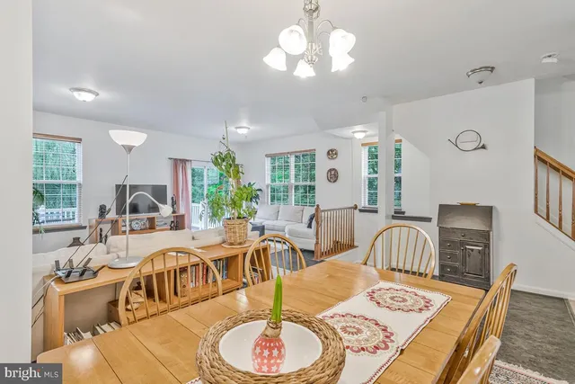 a living room with furniture chandelier and a table