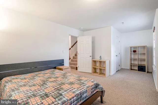 a bedroom with a bed and cabinets