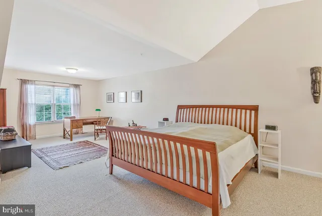 a spacious bedroom with a bed and a table