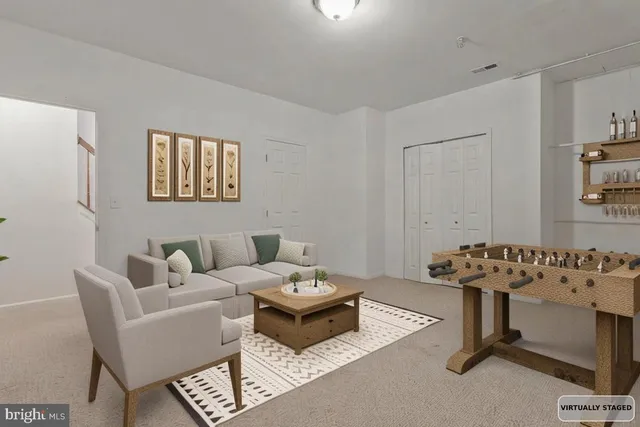 a living room with furniture a couch and a window