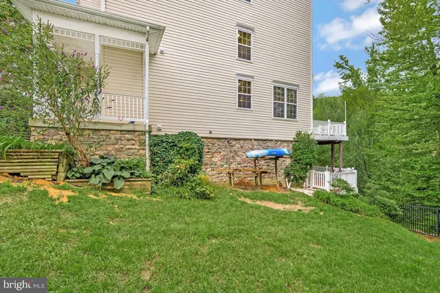 a view of a house with a backyard and sitting area