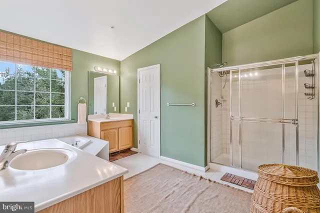 a spacious bathroom with a granite countertop sink and a mirror