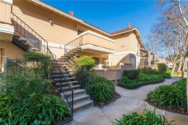 a view of a house with a yard and plants