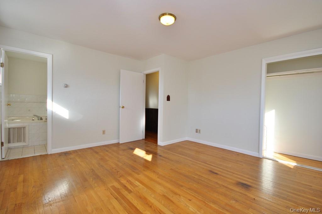 51 Forestburgh Road Forestburgh, NY 12777 - Photo 16 of 35 an empty room with wooden floor and windows