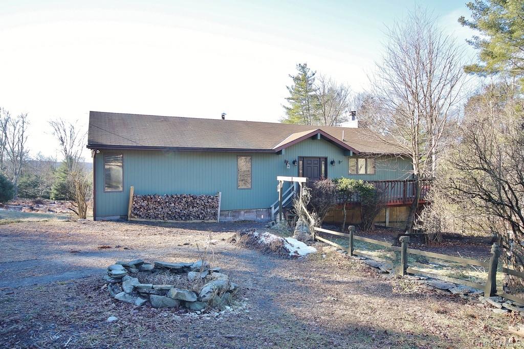 51 Forestburgh Road Forestburgh, NY 12777 - Photo 2 of 35 a front view of a house with a yard and garage