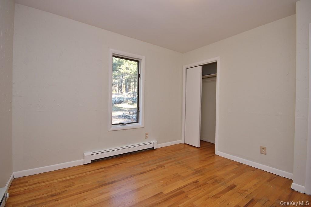 51 Forestburgh Road Forestburgh, NY 12777 - Photo 21 of 35 an empty room with wooden floor and windows