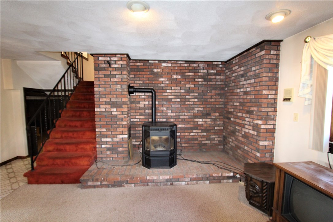 68 Rabbitt Hill Road Cumberland, RI 02864 - Photo 12 of 24 Lower level living room with real brick (stove not included)