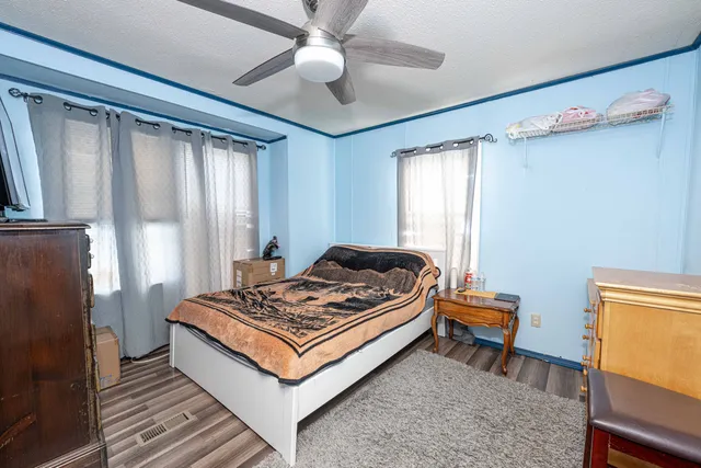 a bedroom with a bed and a chandelier