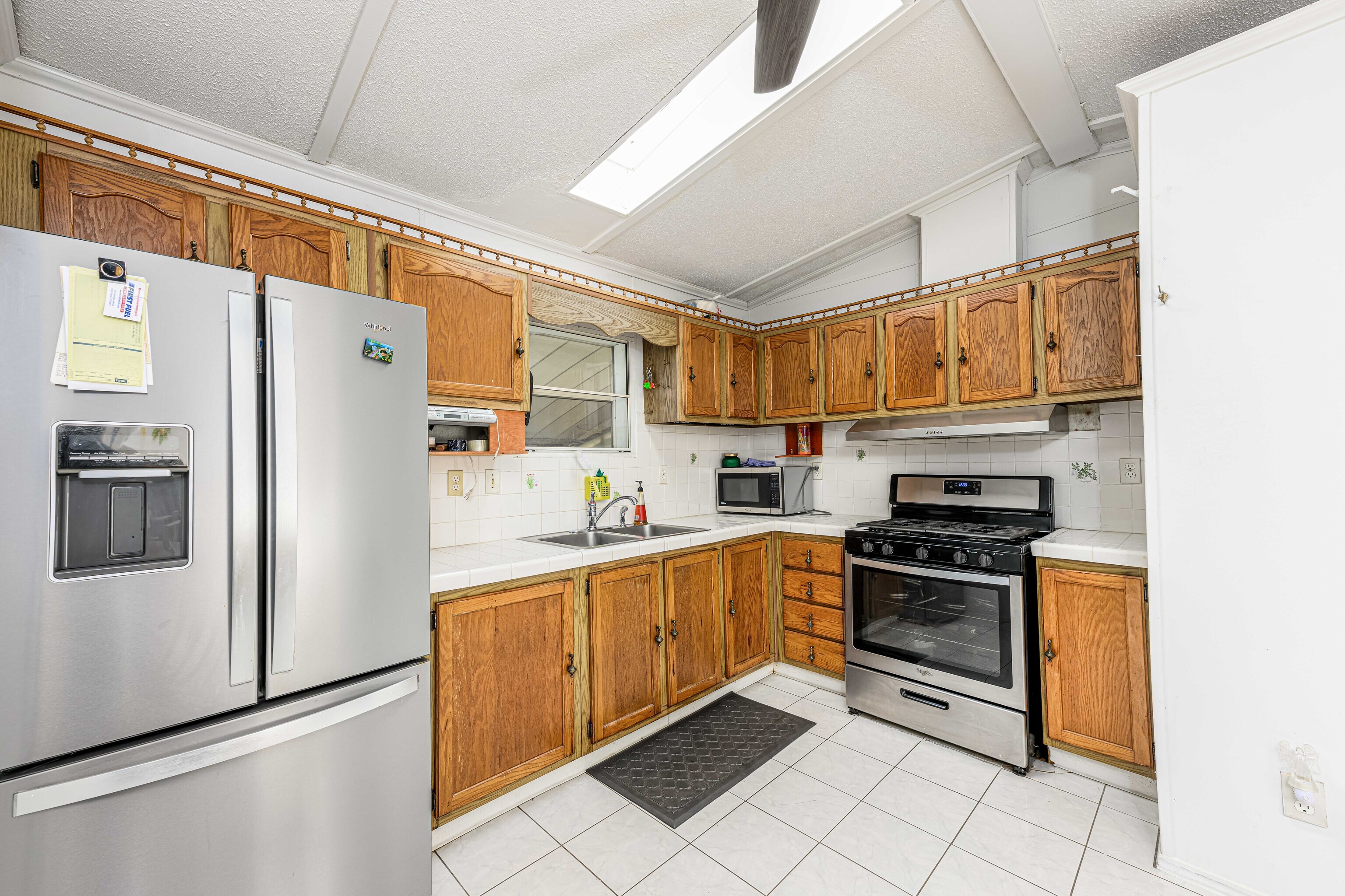 525 East Main Street Branford, CT 06405 - Photo 4 of 20 a kitchen with stainless steel appliances granite countertop a refrigerator sink and stove