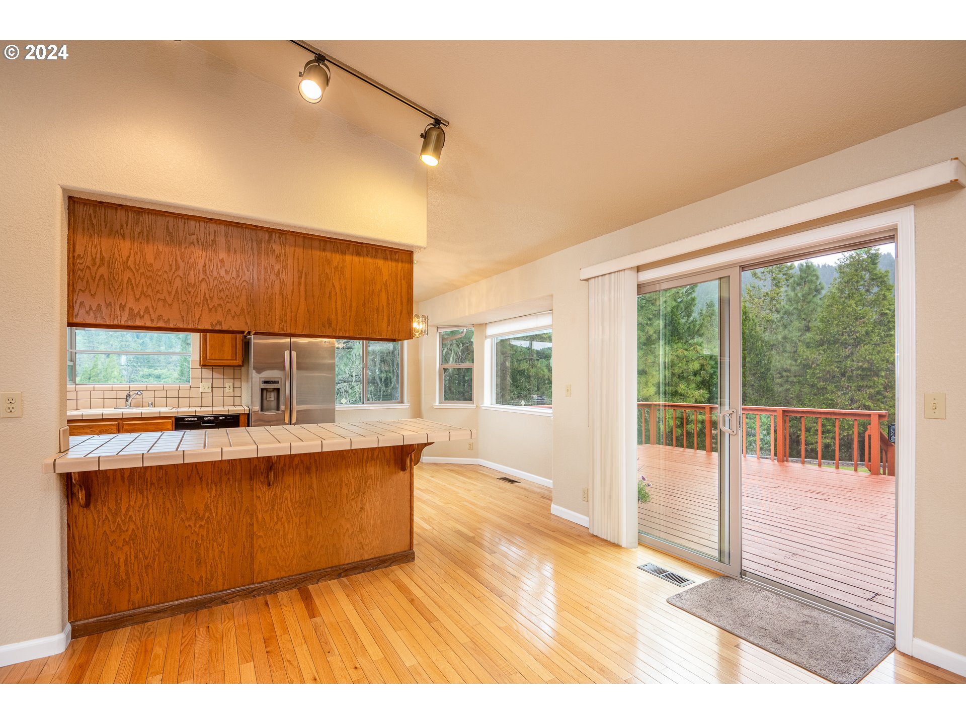 6600 Tunnel Loop Road Grants Pass, OR 97526 - Photo 13 of 43 a living room with stainless steel appliances wooden floor and a large window