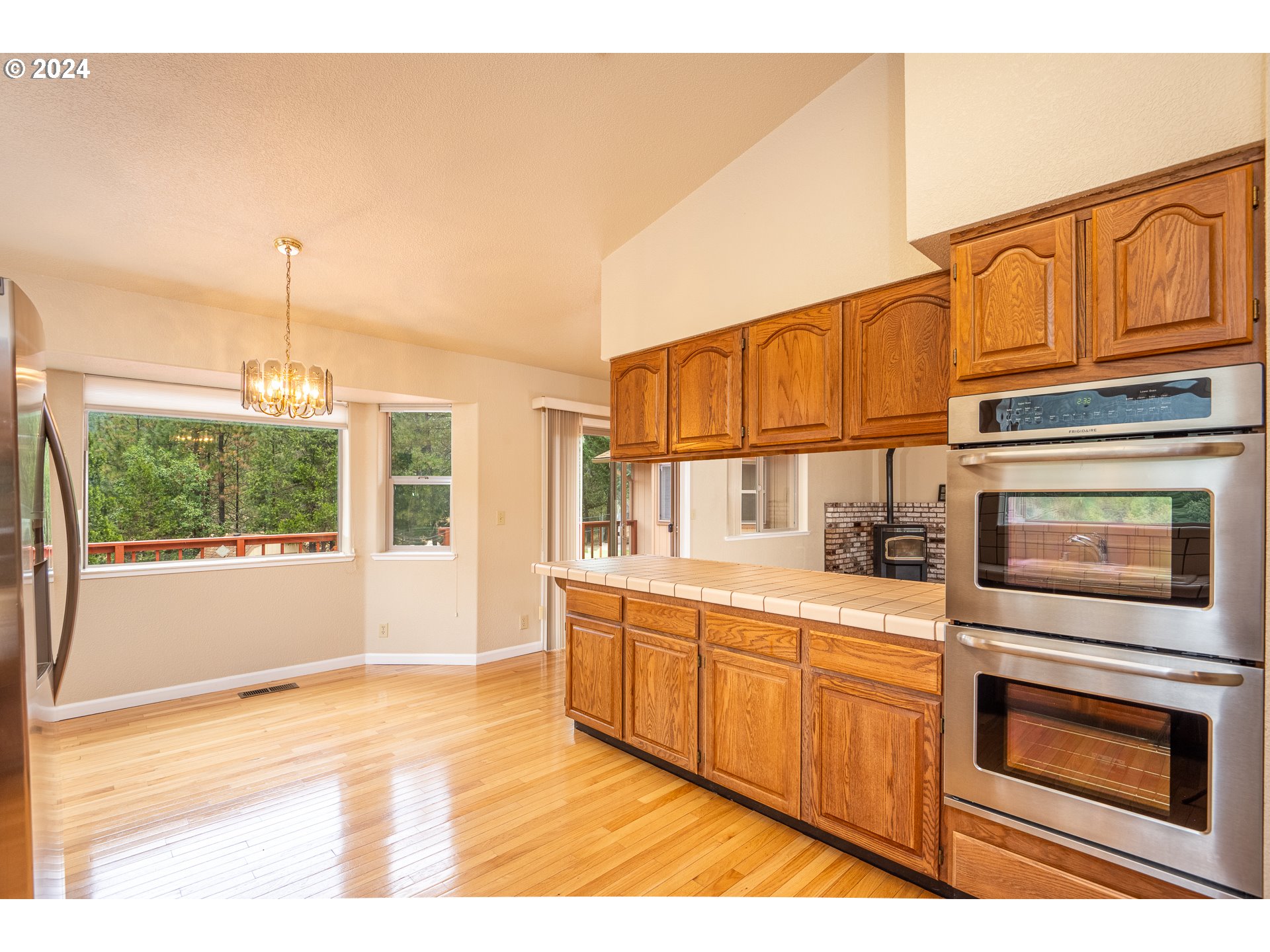 6600 Tunnel Loop Road Grants Pass, OR 97526 - Photo 15 of 43 a kitchen with stainless steel appliances granite countertop a stove and cabinets