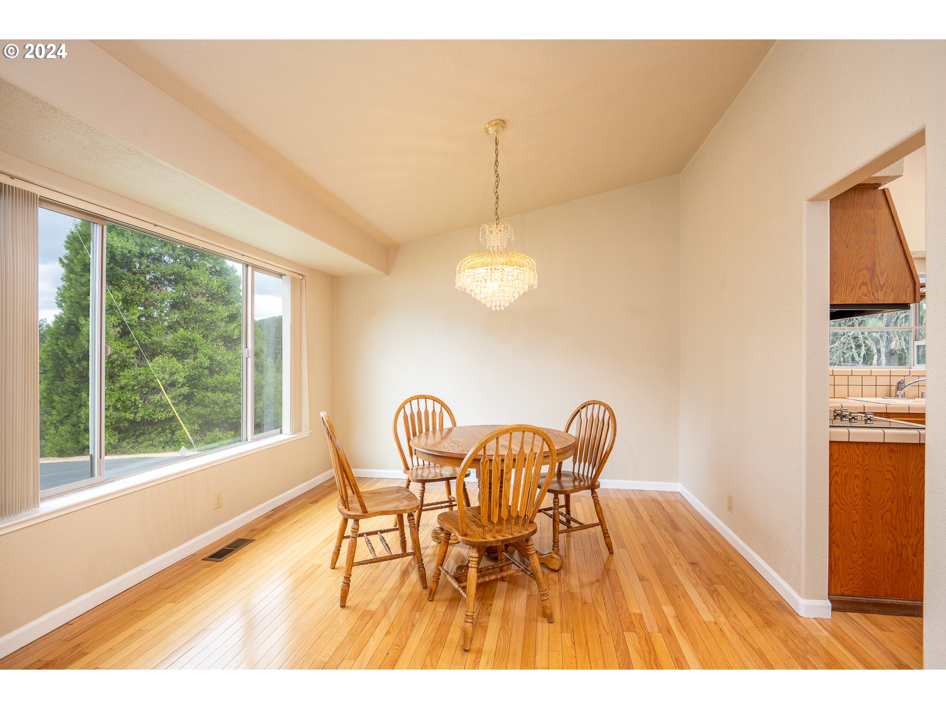 6600 Tunnel Loop Road Grants Pass, OR 97526 - Photo 18 of 43 a view of a dining room with furniture and wooden floor