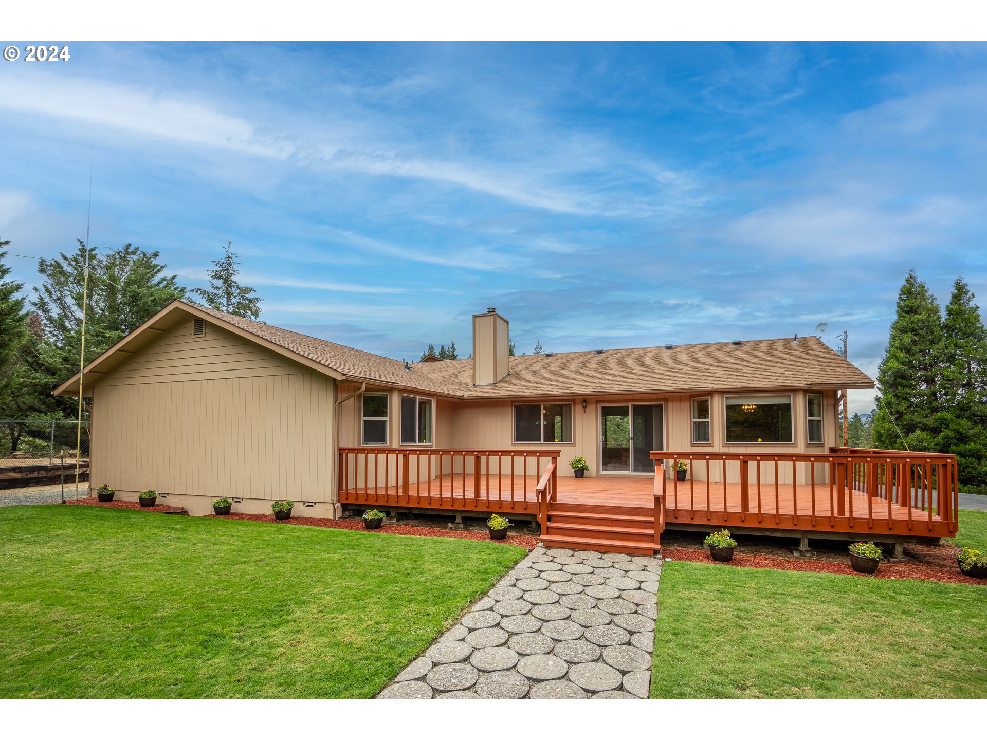 6600 Tunnel Loop Road Grants Pass, OR 97526 - Photo 33 of 43 a view of backyard with a garden and deck