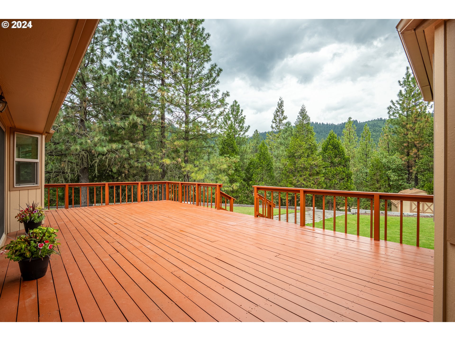 6600 Tunnel Loop Road Grants Pass, OR 97526 - Photo 34 of 43 a balcony with wooden floor and yard in the back