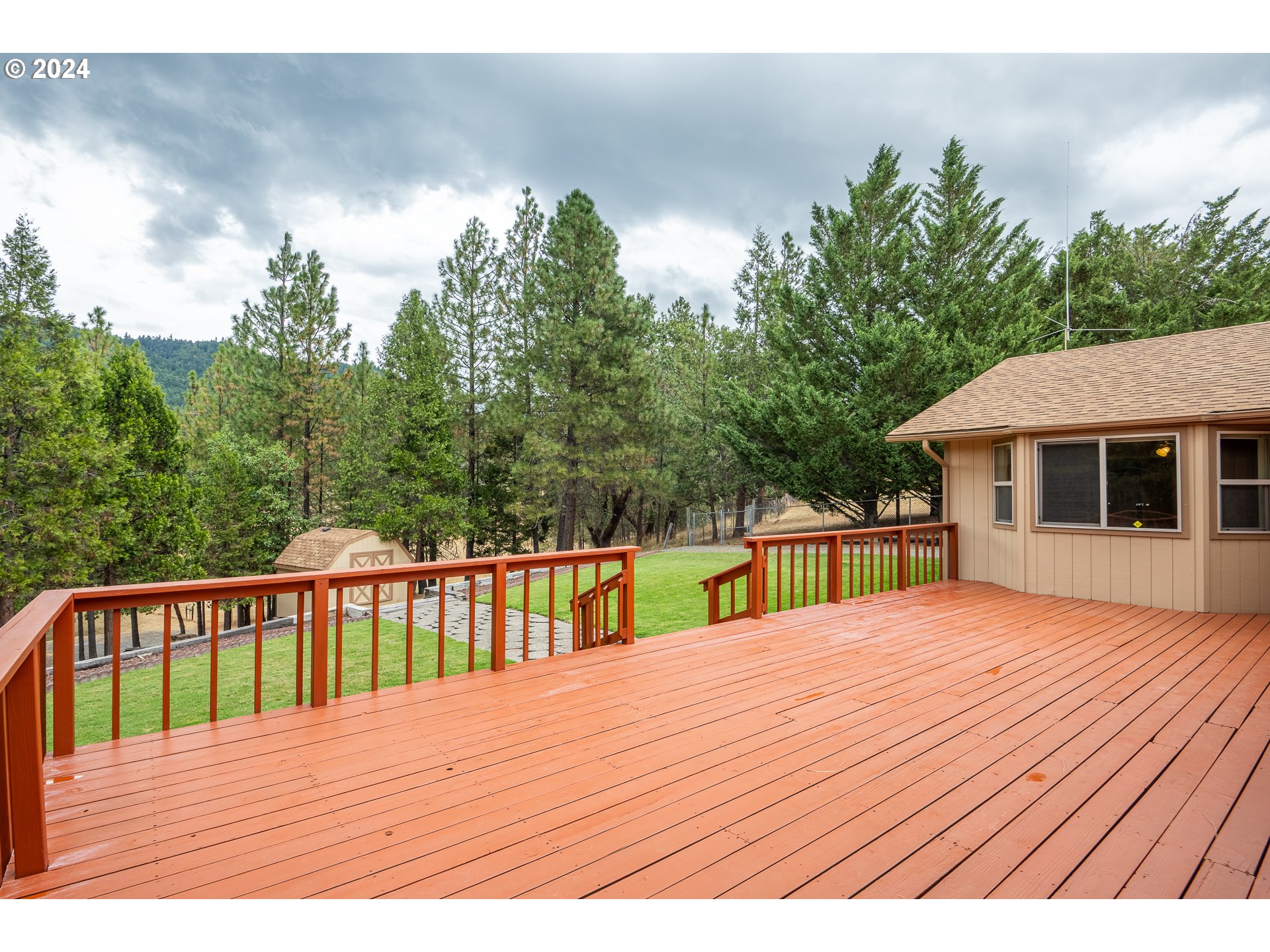 6600 Tunnel Loop Road Grants Pass, OR 97526 - Photo 35 of 43 a deck view with a wooden floor and fence next to a yard