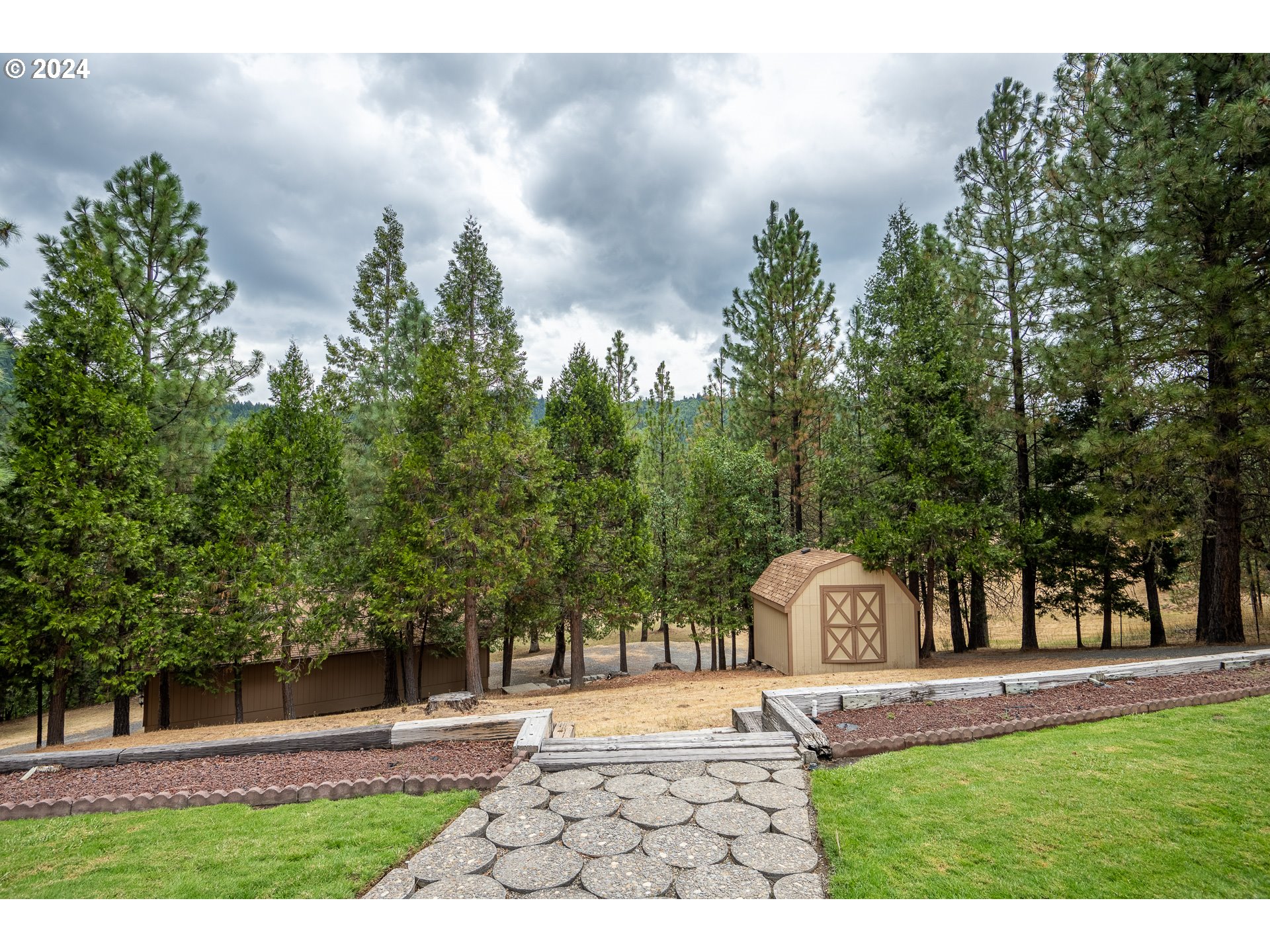 6600 Tunnel Loop Road Grants Pass, OR 97526 - Photo 36 of 43 a front view of a house with garden