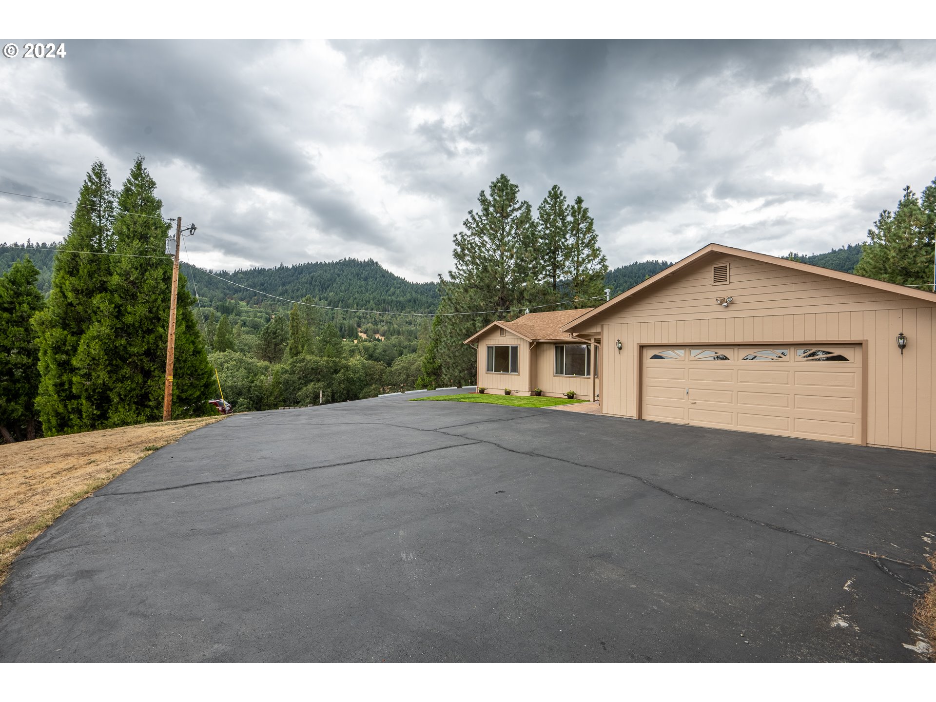 6600 Tunnel Loop Road Grants Pass, OR 97526 - Photo 4 of 43 a view of a house with a yard and a garage