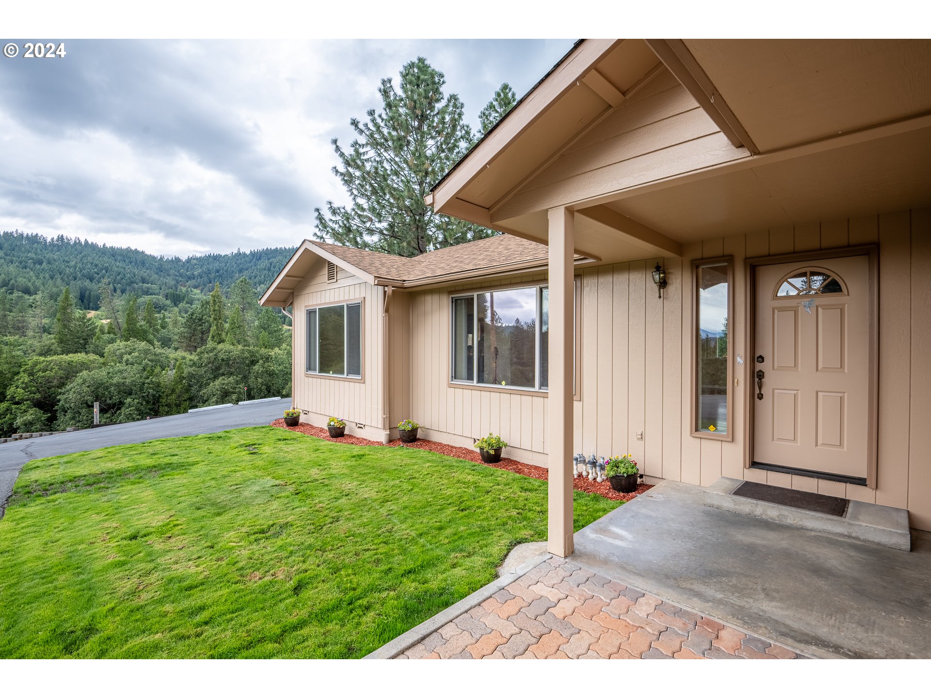 6600 Tunnel Loop Road Grants Pass, OR 97526 - Photo 5 of 43 a view of a backyard with white house