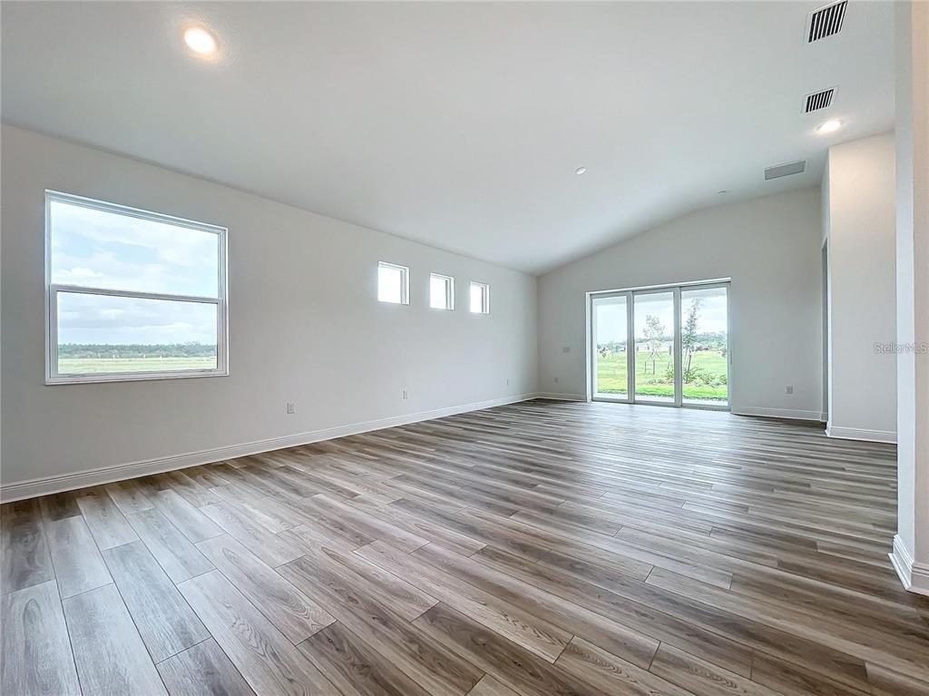 3951 Kennebunk Loop Mount Dora, FL 32757 - Photo 19 of 54 an empty room with wooden floor and windows