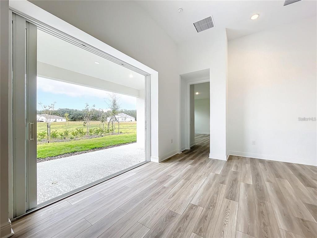 3951 Kennebunk Loop Mount Dora, FL 32757 - Photo 23 of 54 an empty room with wooden floor and windows