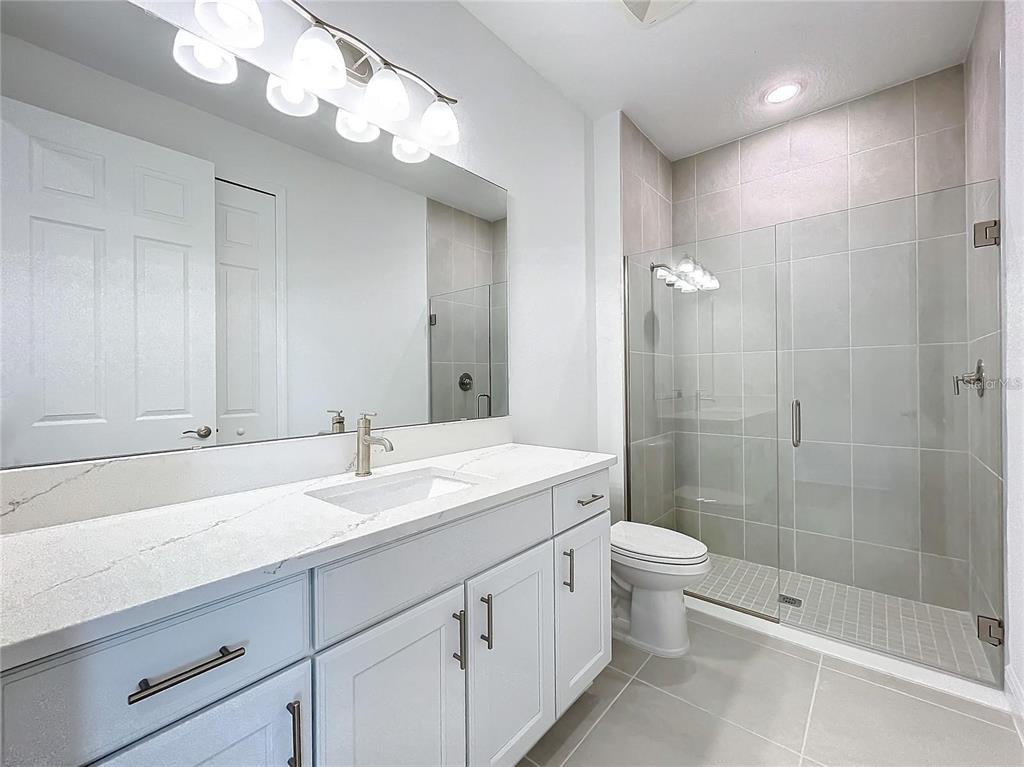 3951 Kennebunk Loop Mount Dora, FL 32757 - Photo 29 of 54 a bathroom with a double vanity sink mirror and toilet