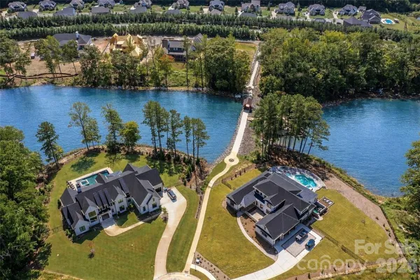 an aerial view of a house with a lake view