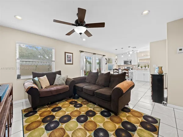 a living room with furniture and kitchen view
