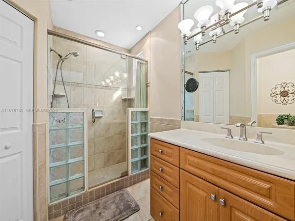a bathroom with a shower sink and mirror