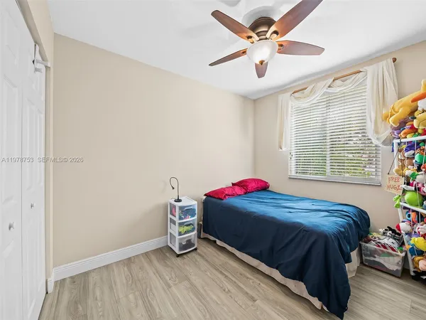 a bedroom with a bed and a ceiling fan