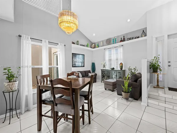 a dining room with furniture and chandelier