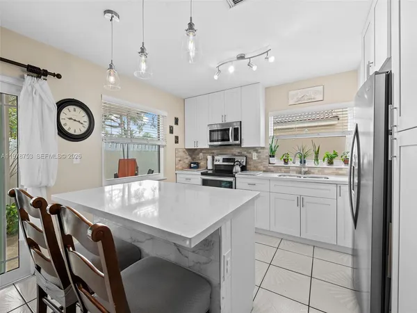 a kitchen with cabinets and stainless steel appliances