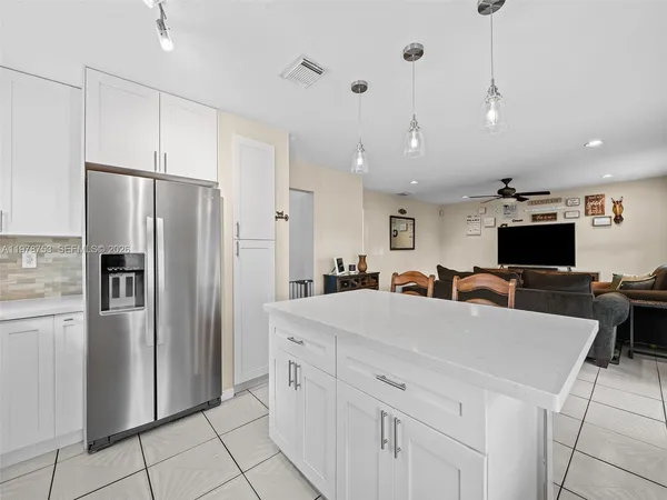 a large kitchen with a table and chairs