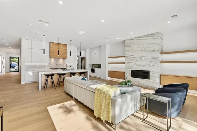 a view of a room with wooden floor furniture and windows