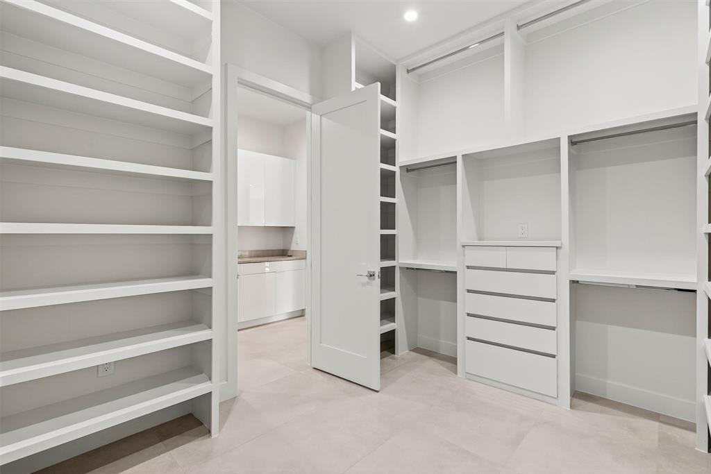 7619 Robin Road Dallas, TX 75209 - Photo 20 of 40 a view of walk in closet with empty racks