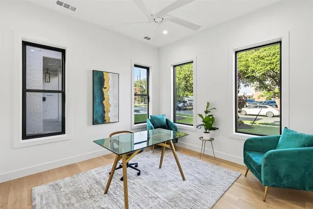 a view of an empty room with a cabinet and a window