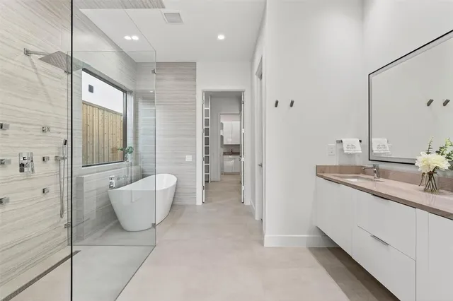 a kitchen with stainless steel appliances granite countertop a stove a sink dishwasher and a refrigerator with wooden floor