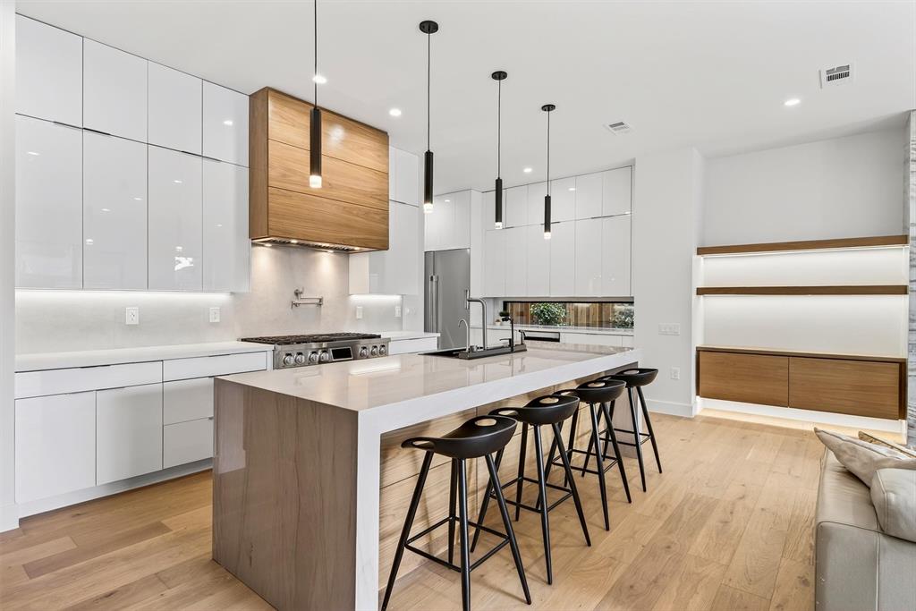 7619 Robin Road Dallas, TX 75209 - Photo 6 of 40 a kitchen with stainless steel appliances granite countertop a stove a sink dishwasher and a refrigerator with wooden floor
