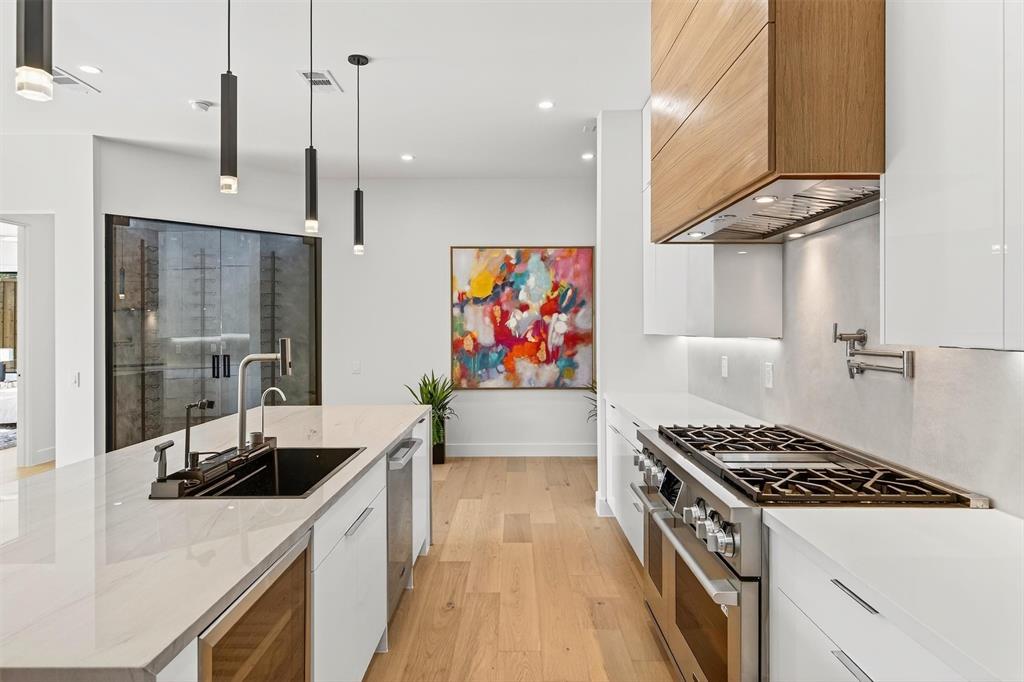 7619 Robin Road Dallas, TX 75209 - Photo 7 of 40 a kitchen with stainless steel appliances a sink a stove and a refrigerator