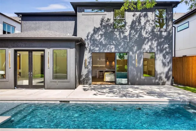 a large kitchen with stainless steel appliances kitchen island granite countertop a stove and a view of living room