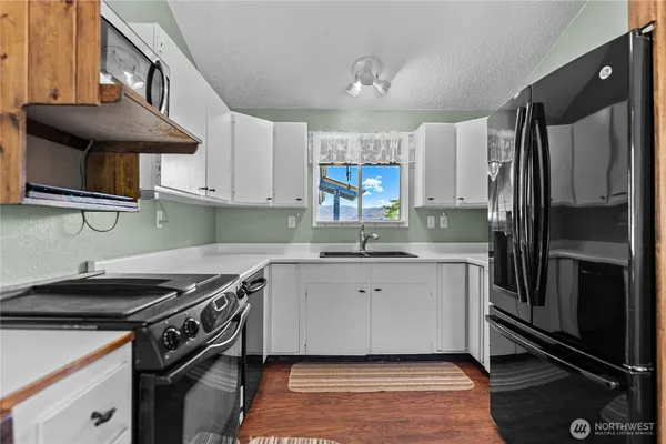 a kitchen with a sink stove and refrigerator