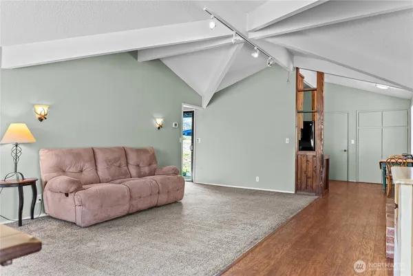 a living room with furniture and a wooden floor