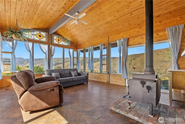 a living room with furniture and a floor to ceiling window