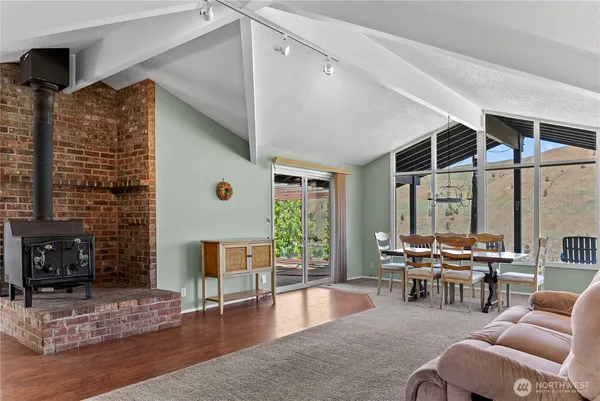 a dining room with furniture and large windows