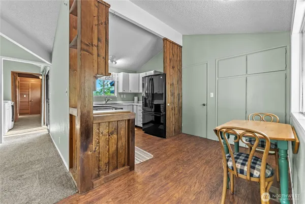 a kitchen with stainless steel appliances kitchen island granite countertop a refrigerator a stove and a oven