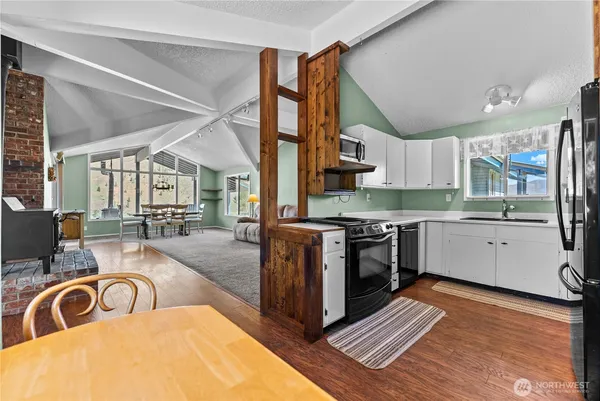 a kitchen with sink a stove and cabinets