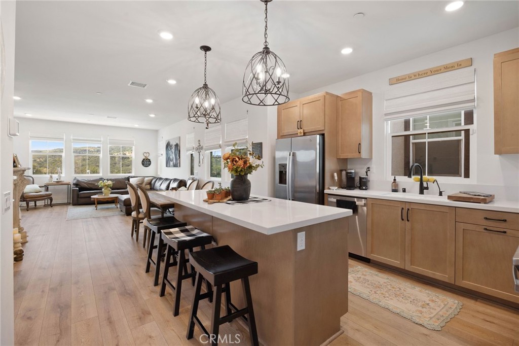 a large kitchen with a table and chairs