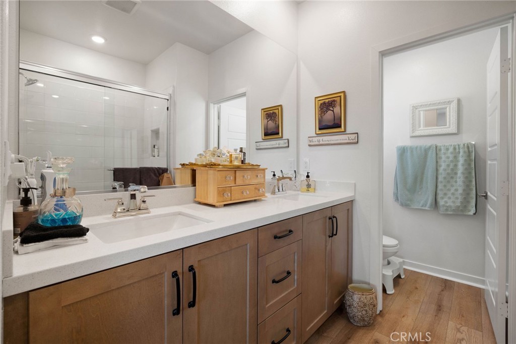 840 Barrel Way Rancho Mission Viejo, CA 92694 - Photo 18 of 57 a bathroom with a double vanity sink toilet and a mirror