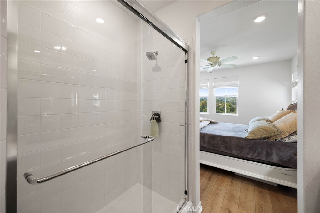 840 Barrel Way Rancho Mission Viejo, CA 92694 - Photo 19 of 57 a bathroom with a granite countertop sink a mirror and shower