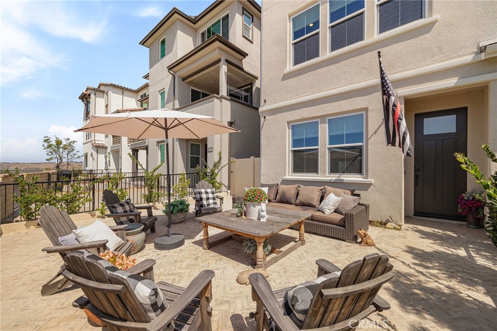 840 Barrel Way Rancho Mission Viejo, CA 92694 - Photo 3 of 57 a view of a patio with couches table and chairs under an umbrella
